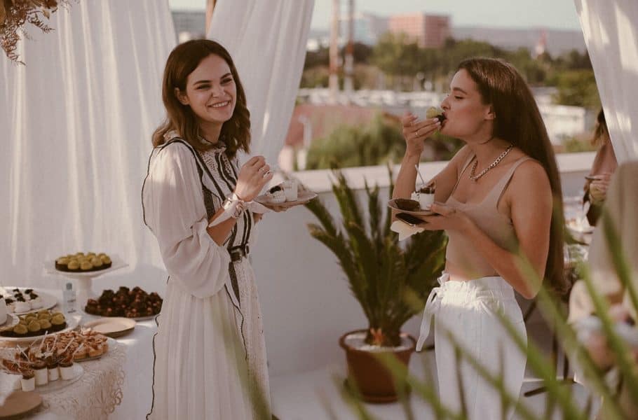 Two women enjoying snacks by Ecaterina Madeline - Unsplash