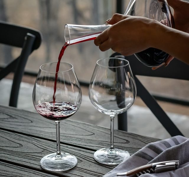 Pouring wine into glass by Theme Photos - Unsplash