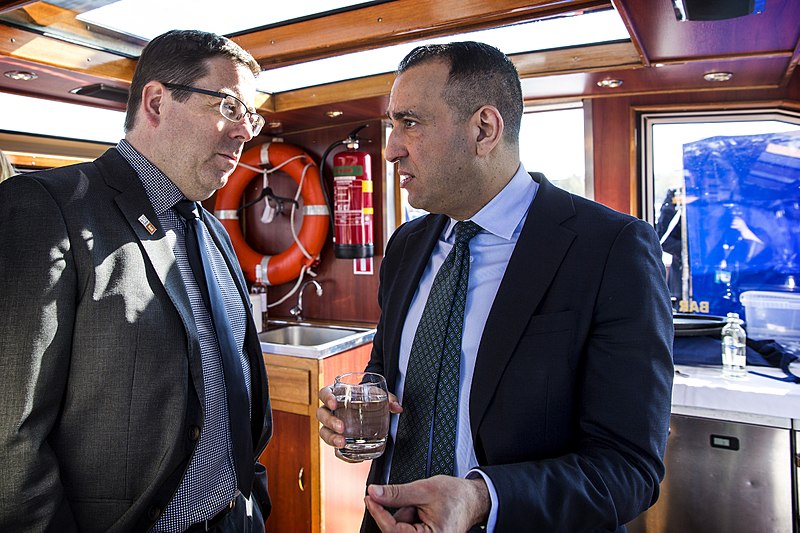 Two men converse on a cruise ship.