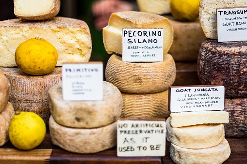 An appetising selection of continental cheeses on sale at Borough Market in London, UK