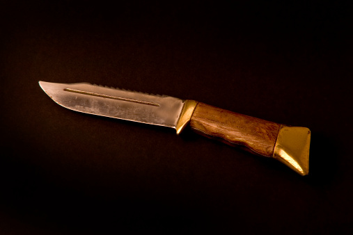 Big hunting knife with dramatic lighting.