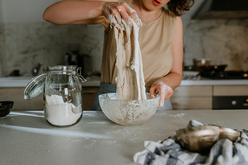 A woman making sourdough bread at home