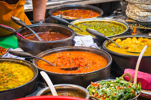 A variety of curries hot food on display at Brick Lane Market in London
